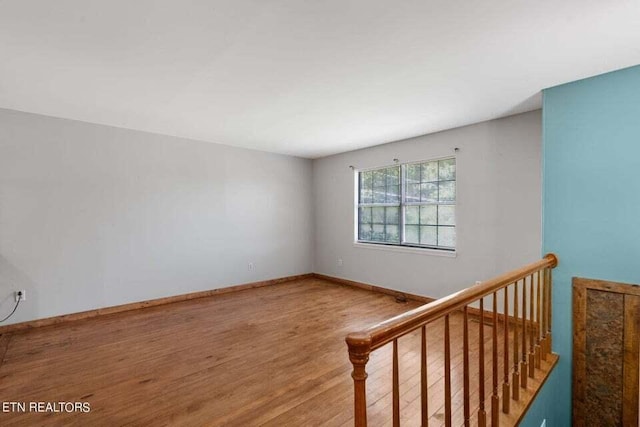 spare room with wood-type flooring