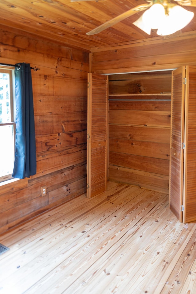 11249 Possum Trail Rd, Harrison, TN 37341 - unfurnished bedroom featuring wooden ceiling, wood walls, a closet, a sauna, and light wood-style flooring
