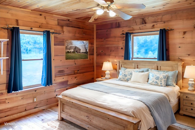 11249 Possum Trail Rd, Harrison, TN 37341 - bedroom with wooden walls, wooden ceiling, multiple windows, light wood-type flooring, and ceiling fan