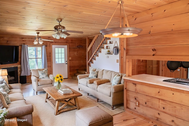 11249 Possum Trail Rd, Harrison, TN 37341 - living room featuring stairway, light wood-type flooring, ceiling fan, wood ceiling, and a fireplace