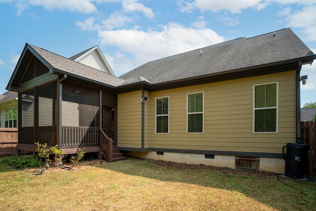 back of house with a sunroom and a lawn