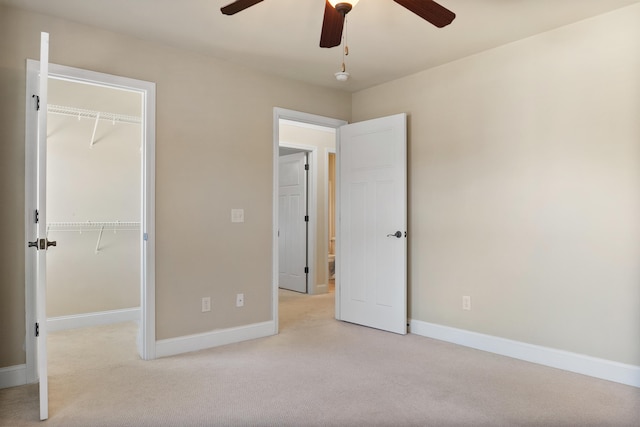 unfurnished bedroom with light colored carpet, a closet, and ceiling fan