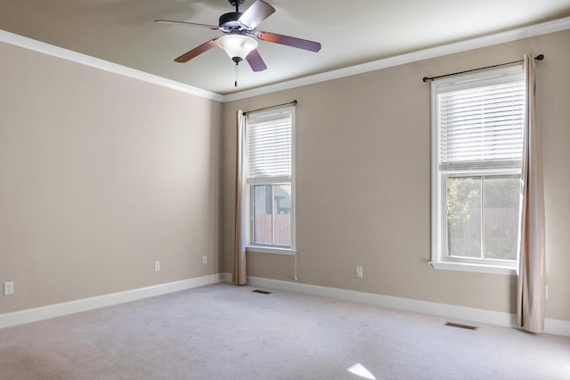 unfurnished room with crown molding, ceiling fan, and light carpet