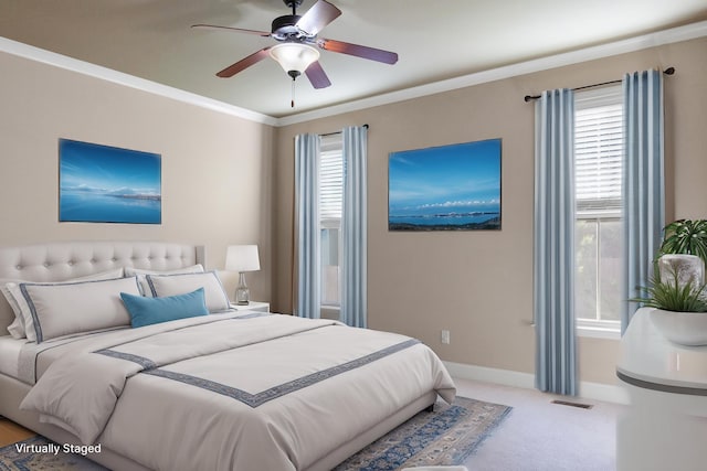 bedroom featuring crown molding, ceiling fan, and light colored carpet