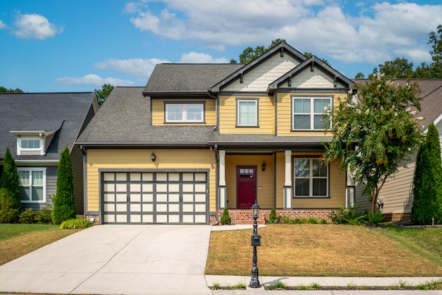 craftsman house with a front lawn and a garage