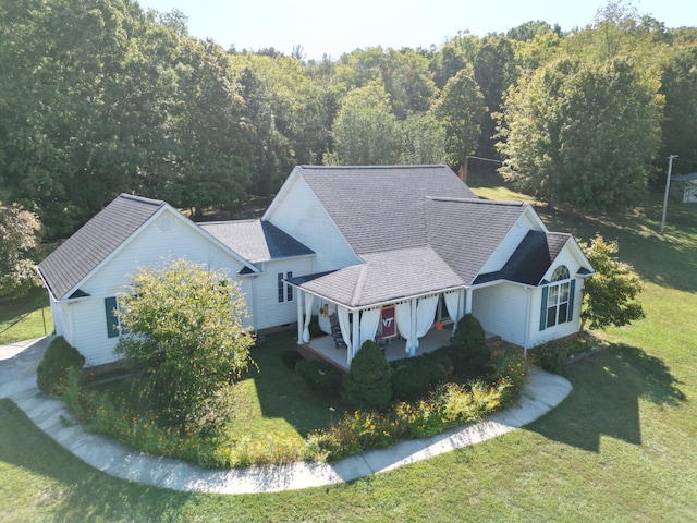 birds eye view of property featuring a view of trees