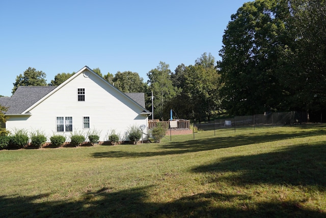 view of property exterior with a yard and fence