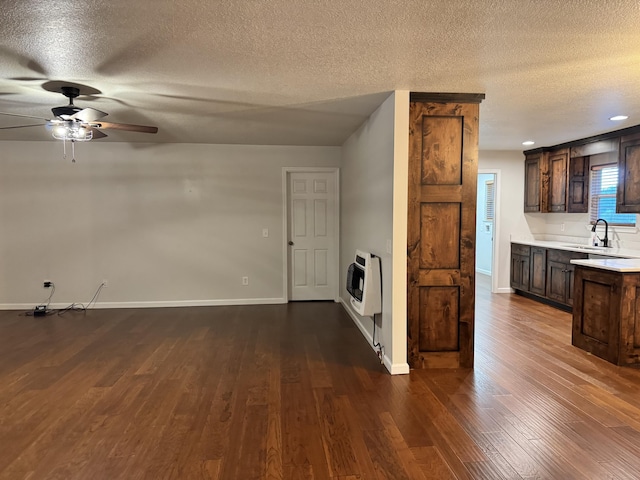140 Croft Chapel Rd, Turtletown, TN 37391 - unfurnished living room with heating unit, a textured ceiling, a ceiling fan, dark wood finished floors, and a sink