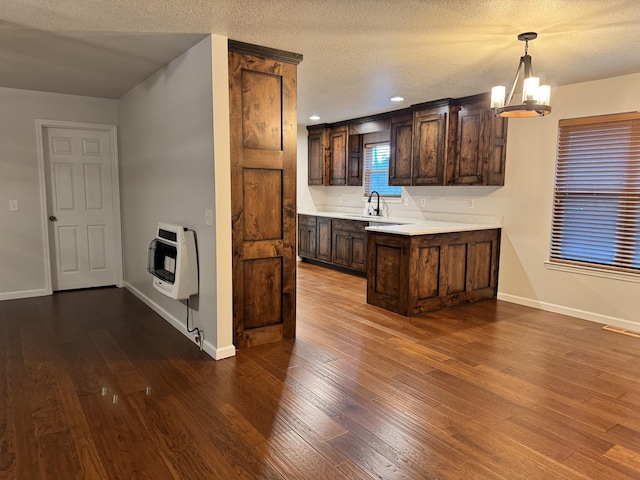 140 Croft Chapel Rd, Turtletown, TN 37391 - kitchen with heating unit, dark brown cabinets, light countertops, dark wood-style flooring, and a textured ceiling