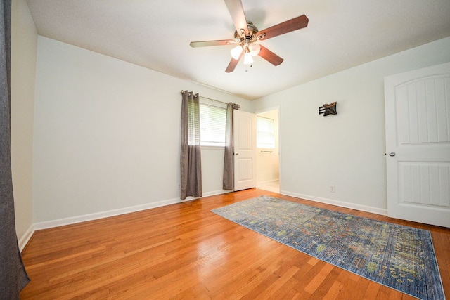 empty room with wood-type flooring and ceiling fan