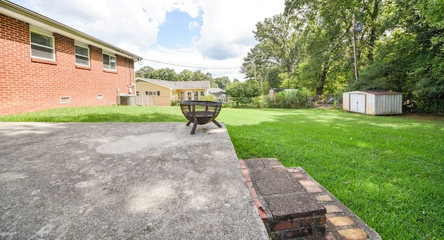 view of yard with a patio, cooling unit, and a storage unit