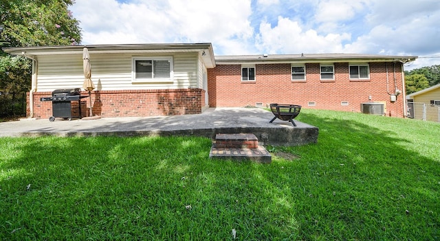 back of property with a yard, a patio, and central air condition unit