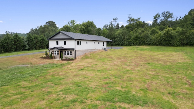 2517 No Pone Rd NW, Georgetown, TN 37336 - view of property exterior featuring a lawn, a view of trees, and a metal roof