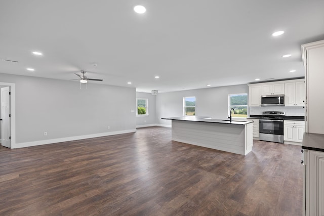 2517 No Pone Rd NW, Georgetown, TN 37336 - kitchen featuring appliances with stainless steel finishes, dark countertops, open floor plan, recessed lighting, and ceiling fan