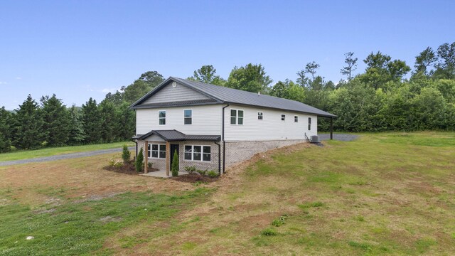 2517 No Pone Rd NW, Georgetown, TN 37336 - view of side of property featuring a lawn, a metal roof, and brick siding