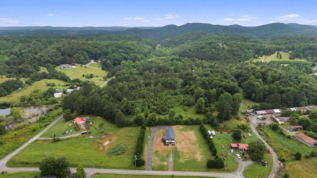 2517 No Pone Rd NW, Georgetown, TN 37336 - aerial view of property and surrounding area featuring a heavily wooded area and a mountain backdrop