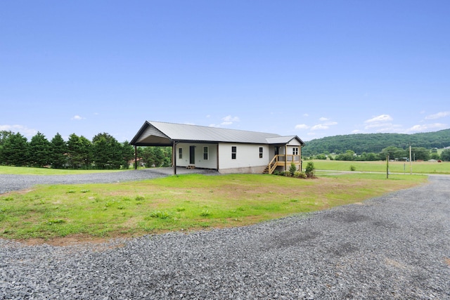 2517 No Pone Rd NW, Georgetown, TN 37336 - view of front of property with driveway, a carport, a front lawn, and a metal roof