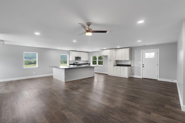 2517 No Pone Rd NW, Georgetown, TN 37336 - unfurnished living room featuring recessed lighting, a ceiling fan, plenty of natural light, and dark wood-style floors
