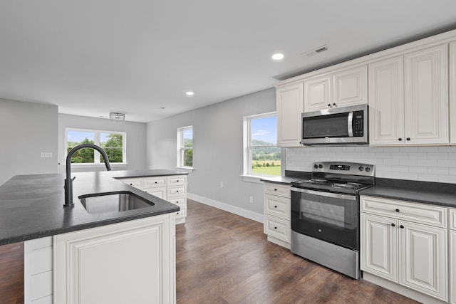 2517 No Pone Rd NW, Georgetown, TN 37336 - kitchen featuring stainless steel appliances, dark countertops, dark wood-style floors, tasteful backsplash, and recessed lighting