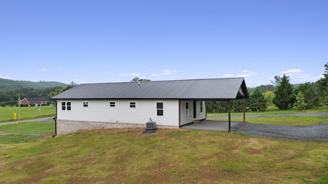2517 No Pone Rd NW, Georgetown, TN 37336 - back of house with a lawn, a carport, a metal roof, and gravel driveway