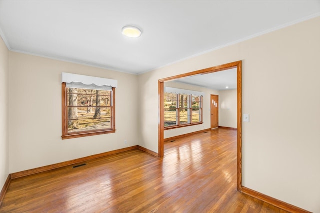 unfurnished room with wood-type flooring and ornamental molding