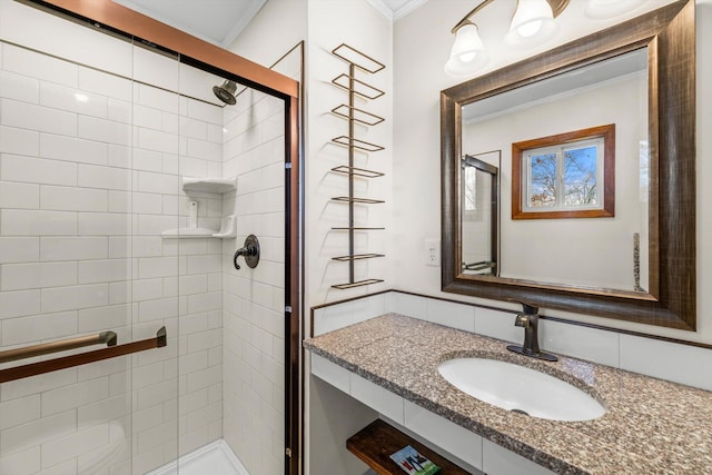 bathroom featuring a shower with door, crown molding, and vanity