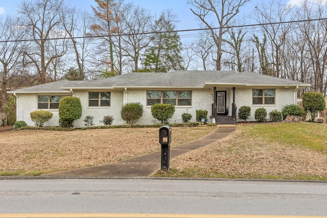 ranch-style home with a front lawn