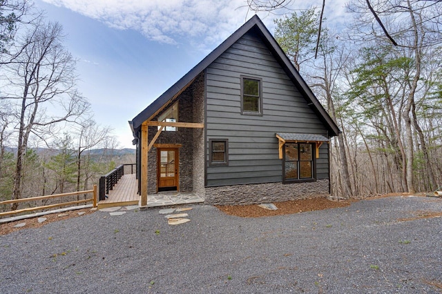 chalet / cabin featuring stone siding