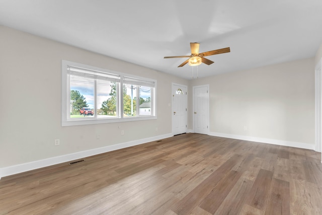 spare room featuring ceiling fan and light hardwood / wood-style floors