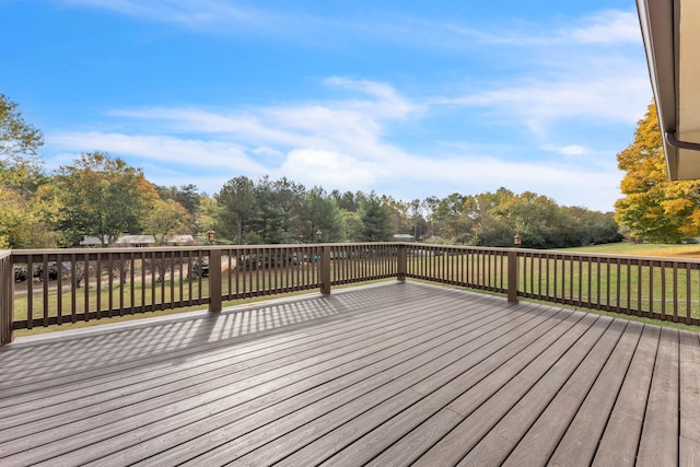 wooden terrace featuring a lawn