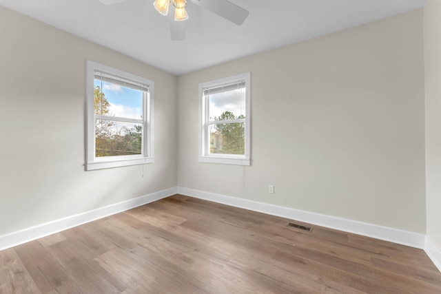 empty room with ceiling fan and light wood-type flooring