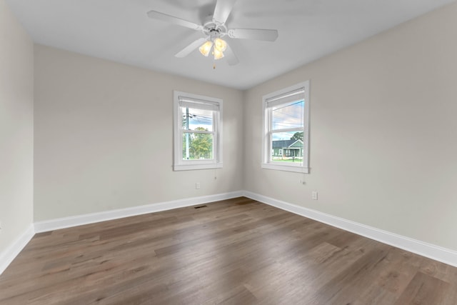 empty room featuring dark hardwood / wood-style floors and ceiling fan