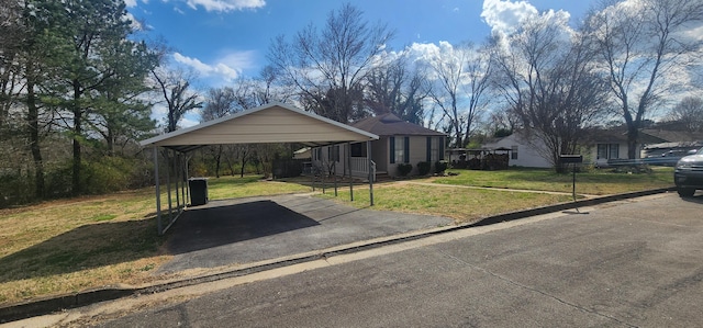 view of front of home with aphalt driveway, a carport, and a front yard