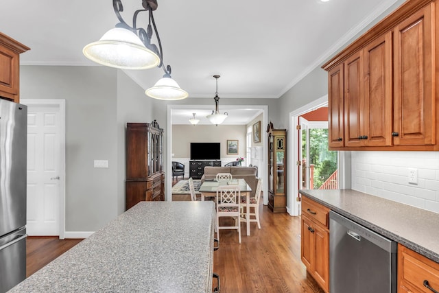 1028 Ivy Manor Ct, Hixson, TN 37343 - kitchen featuring stainless steel appliances, dark wood finished floors, crown molding, brown cabinetry, and backsplash