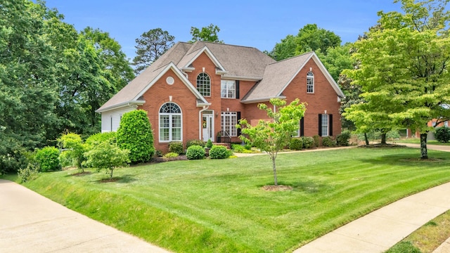 1028 Ivy Manor Ct, Hixson, TN 37343 - view of front of house with brick siding, a front yard, and a shingled roof