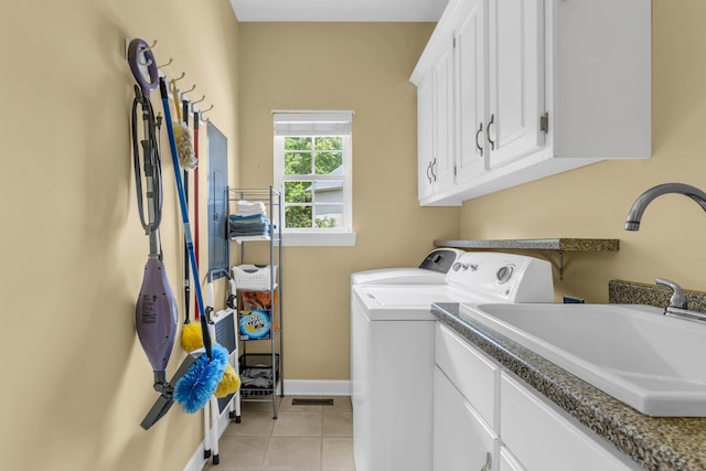 1028 Ivy Manor Ct, Hixson, TN 37343 - laundry room with washing machine and dryer, light tile patterned flooring, cabinet space, and baseboards
