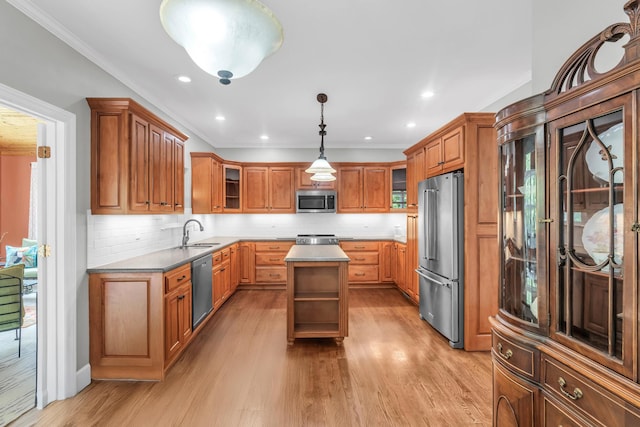 1028 Ivy Manor Ct, Hixson, TN 37343 - kitchen with stainless steel appliances, a sink, brown cabinetry, a kitchen island, and backsplash