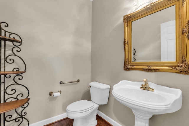 1028 Ivy Manor Ct, Hixson, TN 37343 - half bathroom with baseboards, toilet, wood finished floors, and a sink