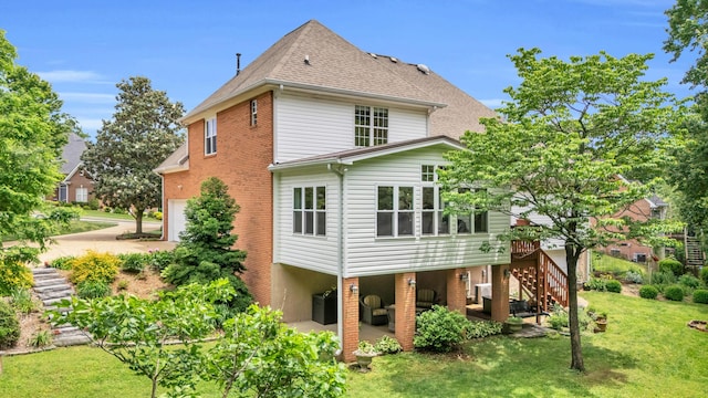 1028 Ivy Manor Ct, Hixson, TN 37343 - rear view of house with stairway, a yard, an attached garage, a deck, and a patio