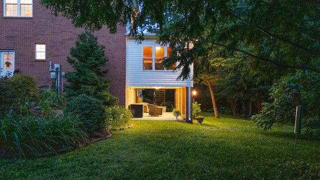 1028 Ivy Manor Ct, Hixson, TN 37343 - back of house featuring a yard, a patio area, and brick siding