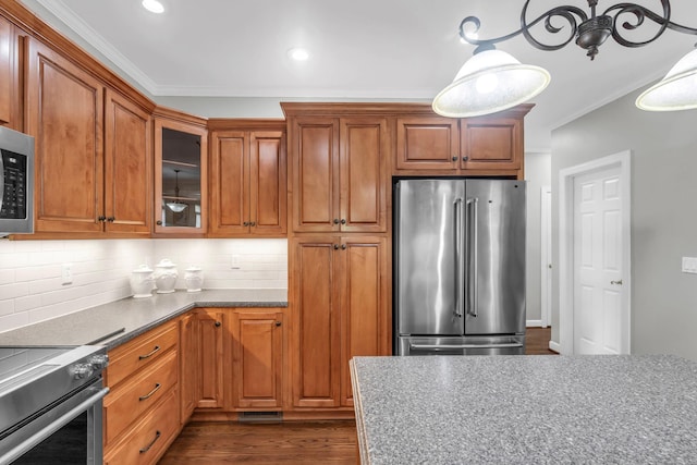 1028 Ivy Manor Ct, Hixson, TN 37343 - kitchen with stainless steel appliances, ornamental molding, tasteful backsplash, brown cabinets, and glass insert cabinets