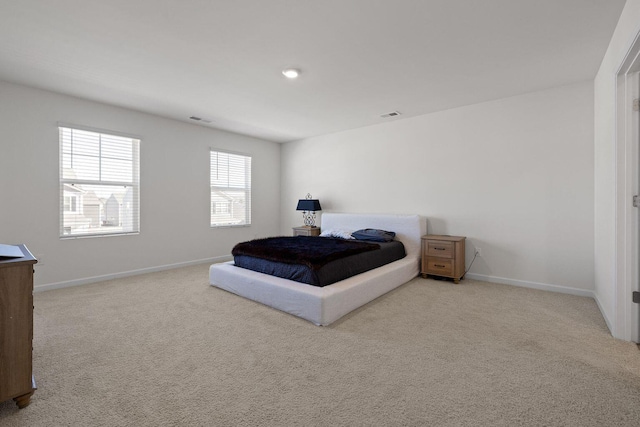 bedroom with carpet flooring, visible vents, and baseboards