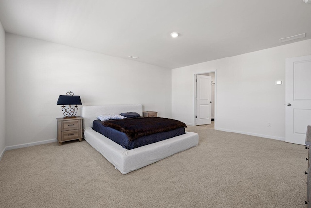 bedroom with visible vents, baseboards, and light colored carpet