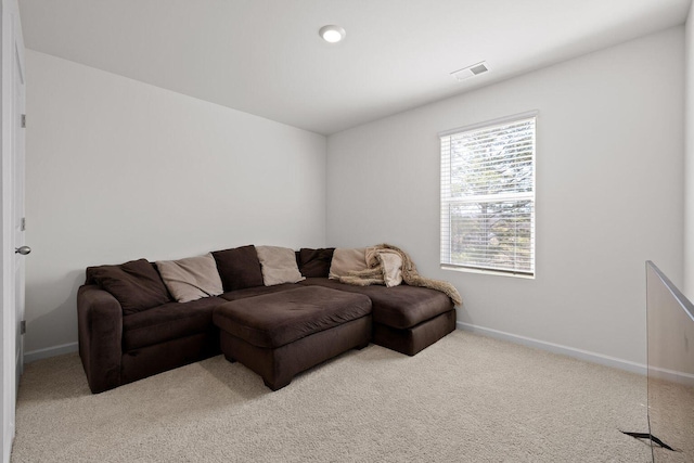 living room with light carpet, baseboards, and visible vents