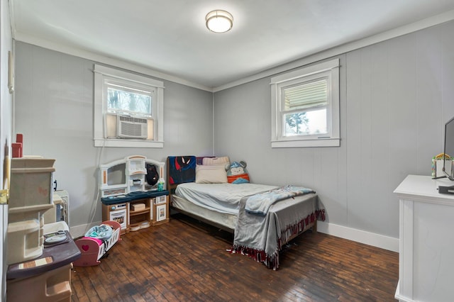 bedroom featuring ornamental molding, cooling unit, and dark wood-type flooring