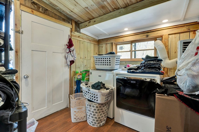 kitchen with washer and dryer, wood walls, and wood-type flooring