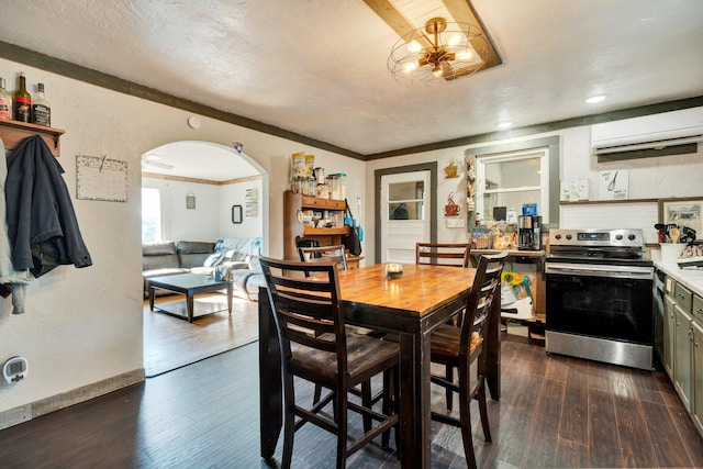 dining room featuring crown molding, dark wood-type flooring, a textured ceiling, and a notable chandelier