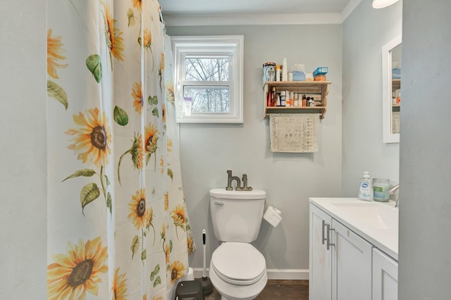 bathroom featuring vanity, toilet, and ornamental molding