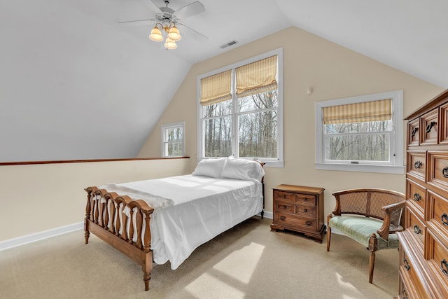 bedroom with visible vents, baseboards, vaulted ceiling, light carpet, and a ceiling fan