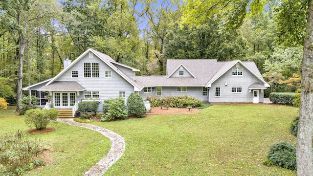 rear view of property with a lawn and a chimney